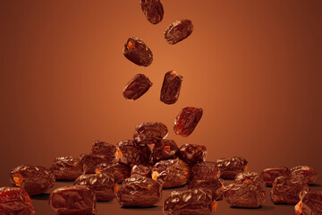 Flying dried dates fruits on brown background