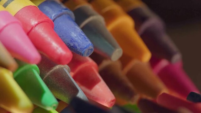 Close-up macro shot of a colorful collection of crayons arranged in a vibrant pattern
