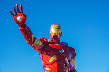 Naklejka premium an iron man statue at the traditional market of Tangga Arung, Tenggarong with blue sky