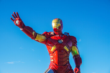 Naklejka premium an iron man statue at the traditional market of Tangga Arung, Tenggarong with blue sky