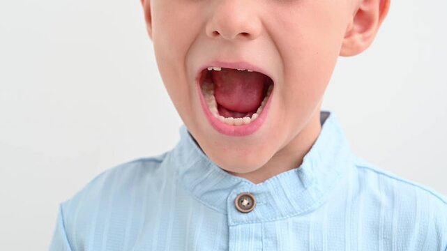 The happy child laughs, showing the gap from the missing baby tooth