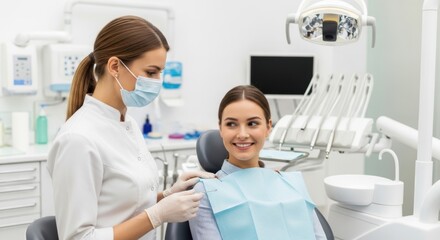 Obraz premium Dentist and patient in a dental clinic with modern equipment and protective masks
