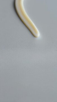 White Cream Squeeze Swatch On Textured Grey Background