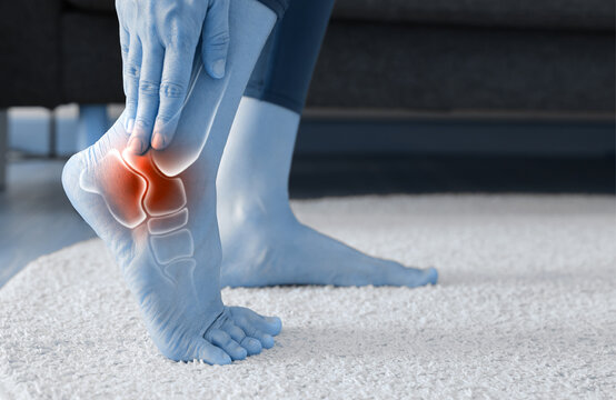 Woman standing and massaging her painful ankle with anatomical bone and joint illustration. Ankle sprain, arthritis, Achilles tendonitis and ligament injury concept for medical health care.