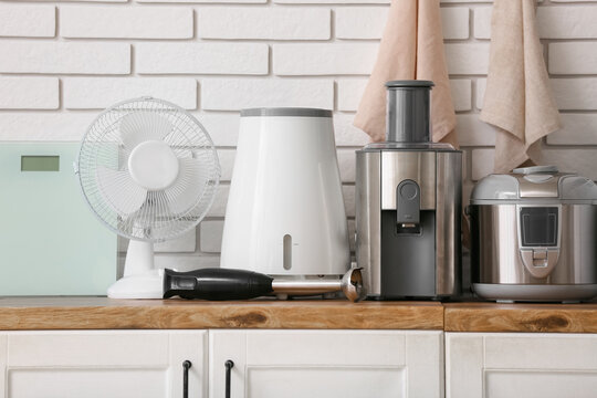 Different modern household appliances with napkins on counter in kitchen