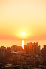 Obraz premium Batumi panorama at sunset. Sunset over horizon along Batumi coast. Colorful coastal city, bathed in warm light of setting sun.
