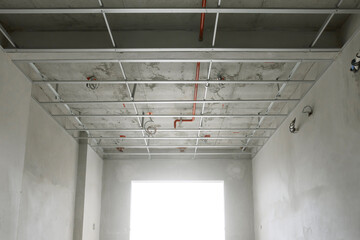 empty room in the structural preparation phase for ceiling installation in a high-rise residential construction project. © noppadon