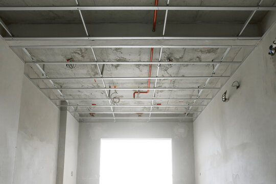 empty room in the structural preparation phase for ceiling installation in a high-rise residential construction project.