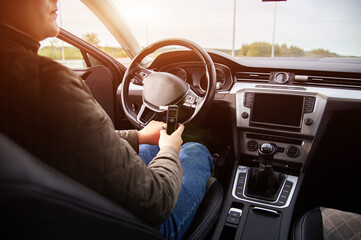 Woman Driver In Car Holds Personal Breathalyzer. Man Checking Sobriety Before Starting Engine.