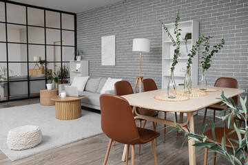 Interior of studio apartment with folding screen, sofa and dining table