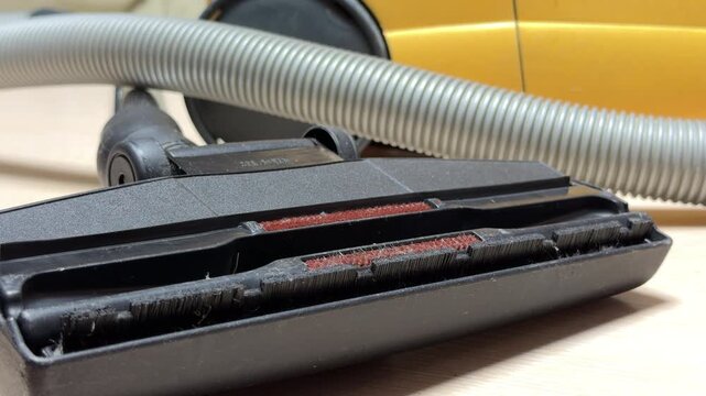 The vacuum cleaner cycles through power, starting with a sharp click followed by a rising whir. As it shuts down, the motor winds down into a fading mechanical sigh.