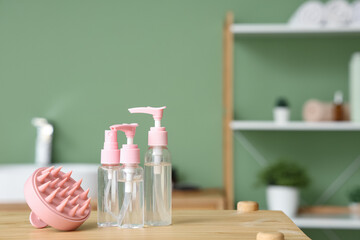 Hair scalp massager with cosmetic bottles on shelf in bathroom, closeup