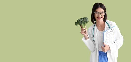 Female nutritionist holding broccoli and meal plan on green background with space for text