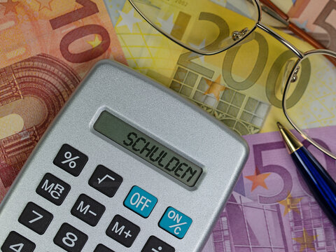 Pocket calculator with the word &ldquo;Debt&rdquo; on the display