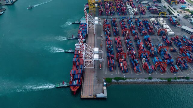 Time lapse Tug boat pulling Cargo container ship go to international yard port. technology freight shipping with smart port.cargo ship carrying container and running for export cargo yard port
