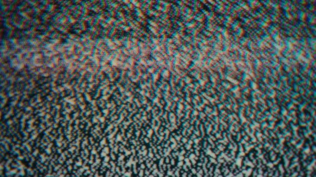 Television static transition with subtitle file text on vintage monitor.