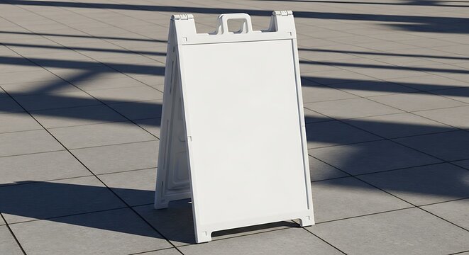 Blank White A-Frame Sign on Paved Ground with Shadows.