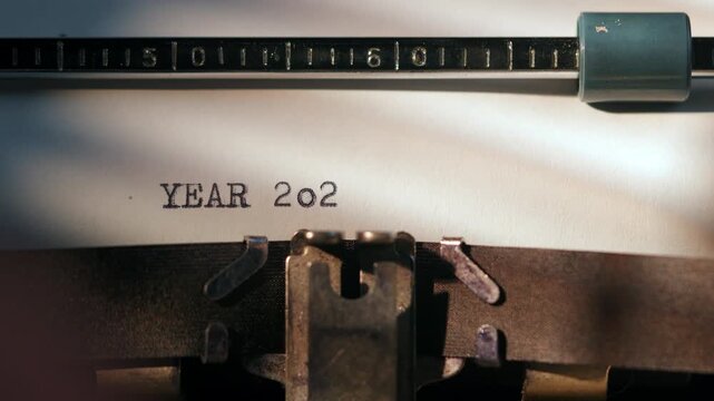 Typing the year 2026 on a typewriter with black keys and a white paper during a writing session