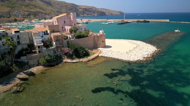 Aerial panorama of Terrasini with boats docked in the marina and the town stretching along the coast.
Smooth drone flyover of Terrasini revealing beach activity, waterfront promenades, and calm sea