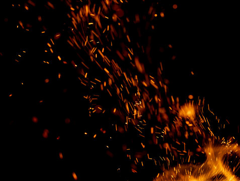 A black background with a lot of orange sparks