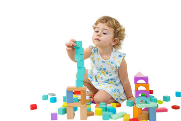 The child plays in the children's room with a wooden constructor. Selective focus.