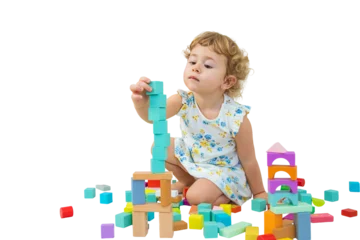 Fotobehang Lego The child plays in the children's room with a wooden constructor. Selective focus.  © yanadjan