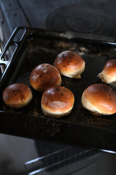Freshly Baked Buns with Poppy Seeds on Baking Sheet