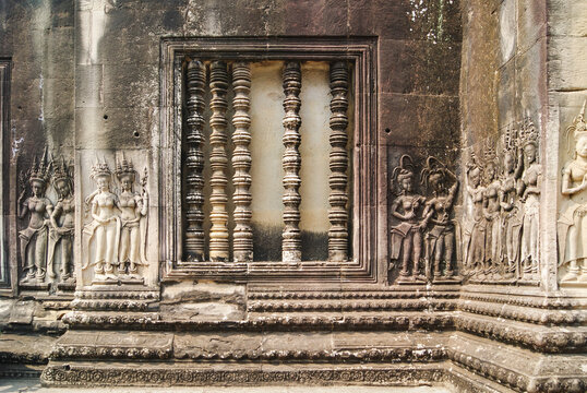 Close-up of intricate carvings on stone temple wall, Cambodia