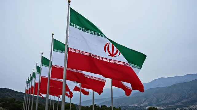 Iranian flags waving in mountainous landscape