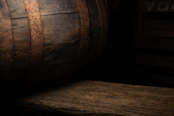 Closeup oak barrel and rough table edge, deep shadow, detailed grain and patina, tactile surface study for artisanal branding