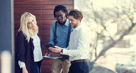 Fototapeta premium Tablet, meeting and business people on balcony for research, finance report and budget proposal. Professional, collaboration and men and woman on tech for financial review, planning and discussion