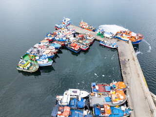 Puerto Natales, Chile: Aerial view of trawlers and fishing boats anchored in the harbor in Puerto Natales in Patagonia in Chile
