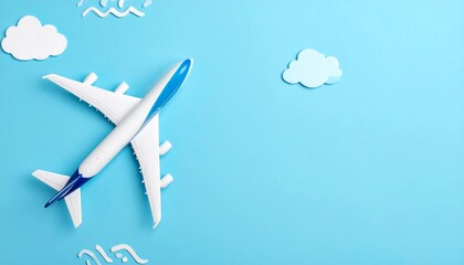 An airplane with white and blue colors is flying in the sky with clouds