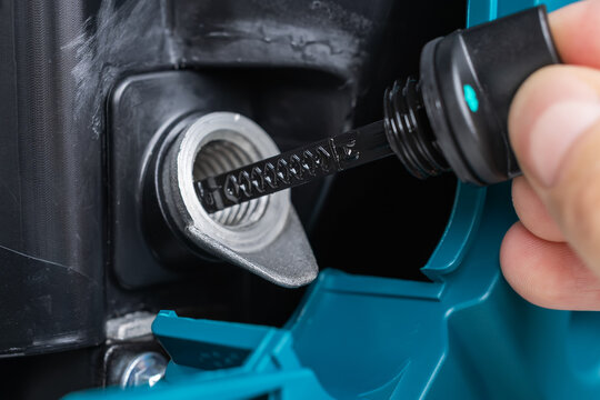 Check generator engine oil level hands checking lube oil level of generator from deep-stick for service and maintenance concept