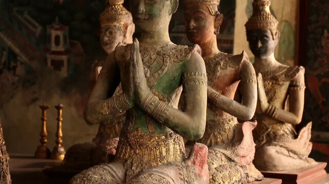 Ancient Thai angel statues in praying gesture (Wai) at  Wat Paichayon Ponsep, Thailand.