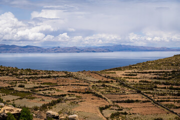 Isla del Sol, Bolivia: Panoramic view of the isla del sol, the sun island,from a hilly viewpoint on the lake titicaca in the Andes in the Bolivia side with cloudy sky