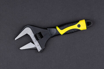 adjustable wrench on dark background for design