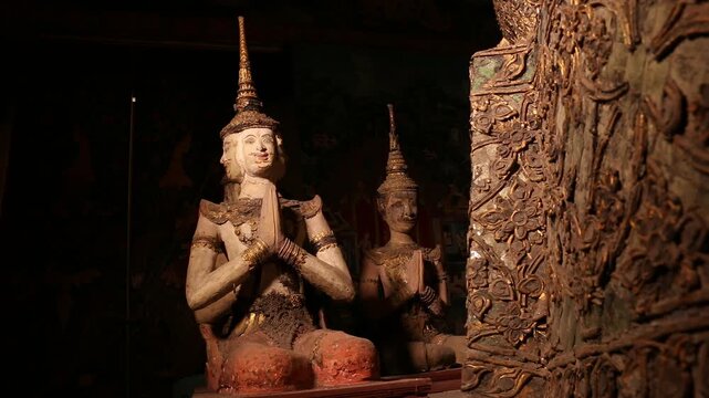 Ancient Thai angel statues in praying gesture (Wai) at  Wat Paichayon Ponsep, Thailand.