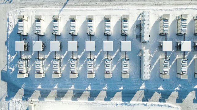 Top down drone view of snow covered battery energy storage containers supporting grid stability and renewable integration in Estonia.