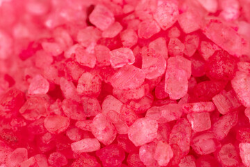 Top view of red bath salt crystals forming a beautiful textured background.