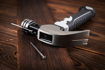 Hammer and nails on wooden surface