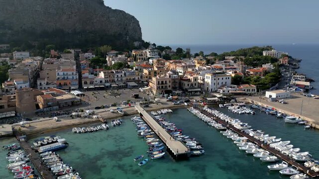 High-angle drone shot capturing Terrasini&rsquo;s coastline, marina, and clear Mediterranean Sea.
Drone footage flying above Terrasini highlighting the contrast between shallow turquoise water and deep b