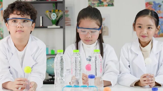 Asian Students Conduct Bernoulli Principle Science Experiment with Ping Pong Balls
