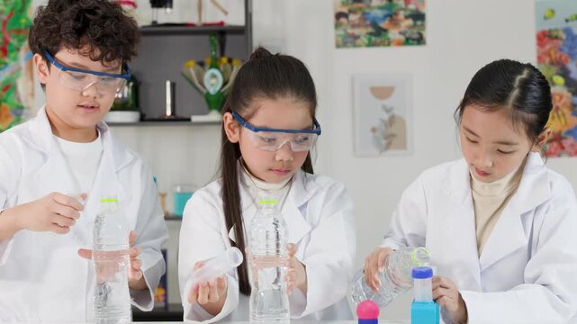 Asian Students Conduct Bernoulli's Principle Science Experiment with Water Bottles
