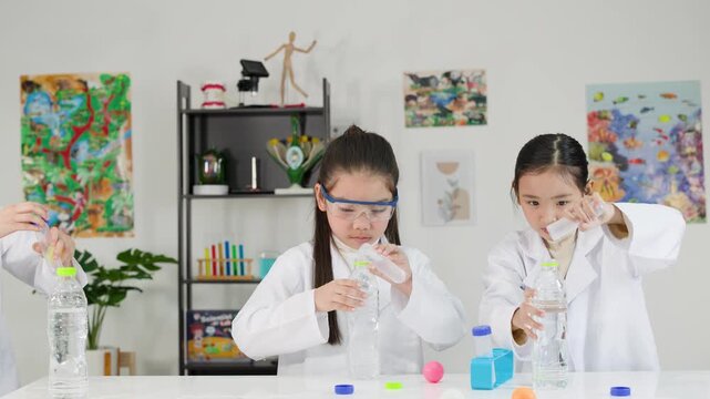 Asian Students Conduct Bernoulli Principle Science Experiment with Ping Pong Balls