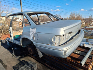 Part of a car body. The body of a car on the roof of a garage
