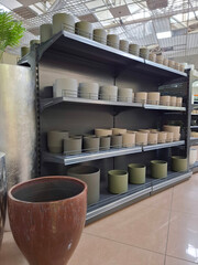 Fototapeta premium Ceramic flower pots on supermarket shelves. Ceramic products in flower shop