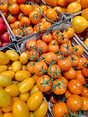 Orange and yellow tomatoes at grocery store