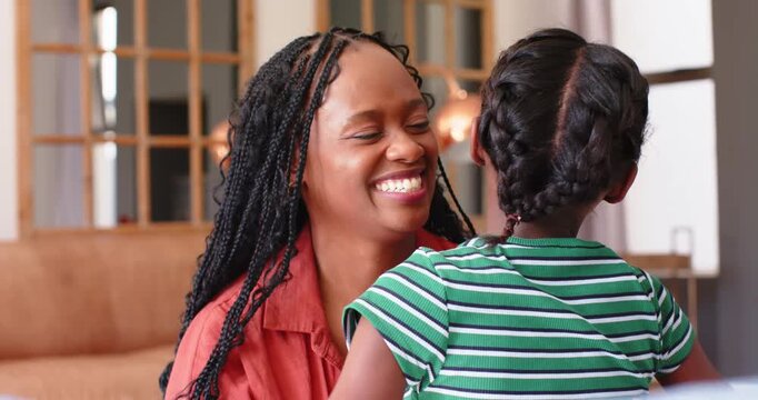 Mother and child, child wrapping around neck, mother cupping face, kissing brow on sofa for comfort