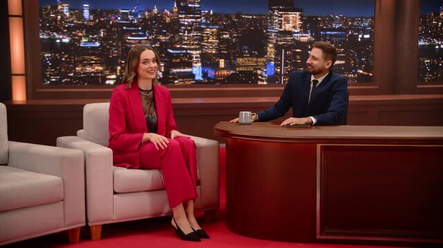 Male Talk show Host Interviews a Female Guest on a Late Night Set, Fun Gossip, Happy Jokes, Career Chat. Friendly Talk for Viewers. TV Screen Replacement Content. Mockup Playback Television Studio
